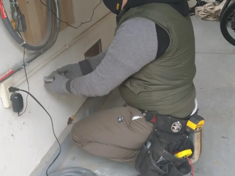 Electrician performing outlet wiring in a Grangeville garage